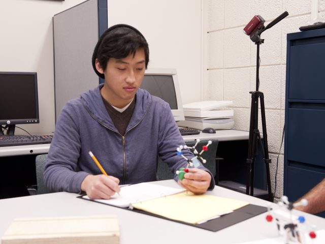 Image of Student Looking at a Chemistry Model